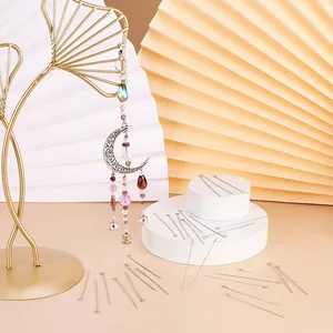 Silver metal eye pins for DIY jewelry making shown with crystal moon suncatcher detail