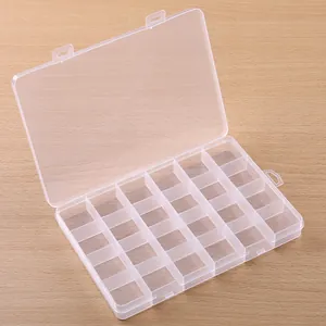 Detail view of 24-compartment transparent plastic storage box for jewelry parts.