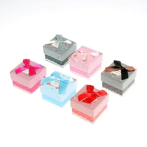 Set of six colorful square gift boxes with striped lids and decorative satin bow ribbons