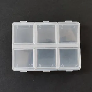 Top view of a 6-compartment transparent plastic storage box with numbered lids and Braille