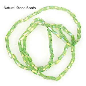 Detailed macro view of 2x4mm faceted light green glass beads for DIY jewelry making