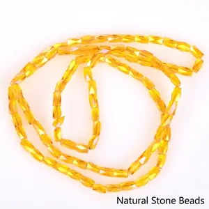 Close-up of amber yellow 2x4mm faceted glass beads for DIY jewelry making