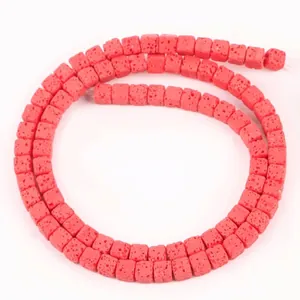 Close-up showing the unique porous texture of red 4x4mm square lava stone beads