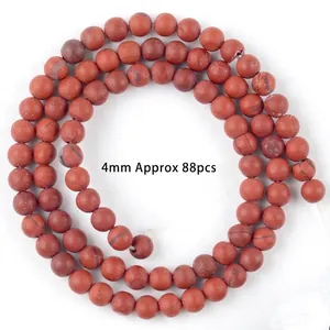 Detailed view of 4mm natural red jasper beads for DIY jewelry making.