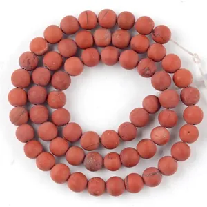 Close-up of 6mm natural red jasper stone beads strand for DIY jewelry making projects