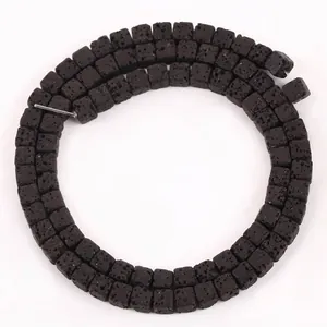 Macro detail shot of 4x4mm square black natural lava stone beads for DIY jewelry making