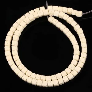Close-up view of 4x4mm white square volcanic stone beads for DIY jewelry making material