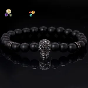 Close-up of black matte 8mm beads bracelet with a micro-paved skull charm