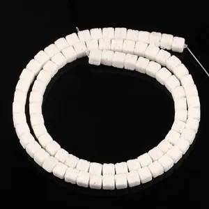 Close-up view of 4x4mm white square porous lava stone beads for DIY jewelry crafting