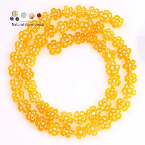 Detailed macro view of 8mm flat yellow flower glass beads for handmade DIY jewelry making