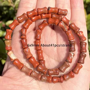 Detail of 6x9mm red jasper spacer beads for DIY jewelry making, 41pcs per strand.