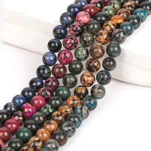 Close-up of multicolored snowflake turquoise round beads for DIY jewelry making.