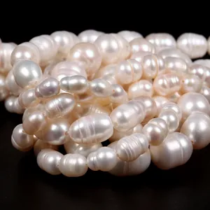 Macro view of natural white freshwater rice-shaped pearl strands showing luster and texture
