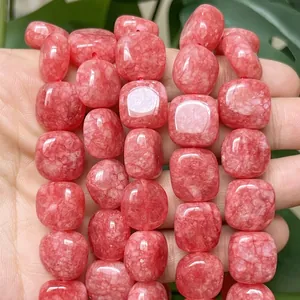 Macro detail of 14x14mm red chalcedony flat square beads for DIY jewelry crafts