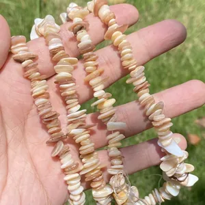 Macro view of bohemian natural chip shell beads in peach and white for DIY jewelry
