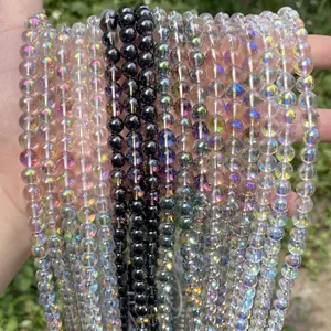 Detailed macro view of iridescent AB and black crystal round beads for DIY jewelry making.