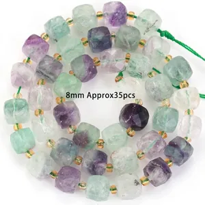 Macro detail of natural multi-color faceted fluorite cube beads for jewelry making.