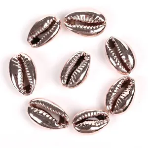 Close-up detail of rose gold electroplated cowrie shell beads for DIY jewelry making