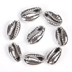 Close-up of metallic silver electroplated cowrie shell beads for DIY jewelry making