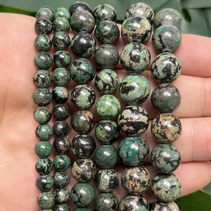 Macro view of polished green snowflake turquoise stone beads for DIY jewelry making