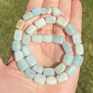 Macro view of light blue natural Amazonite square beads with unique stone textures.
