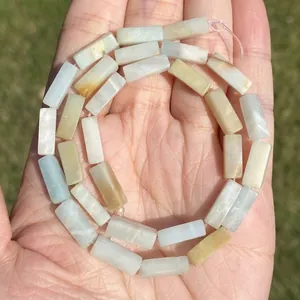 Detailed view of natural Amazonite rectangular bar beads held in hand showing stone textures
