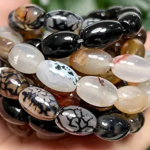 Close-up macro view of polished dragon vein agate rice beads for DIY jewelry
