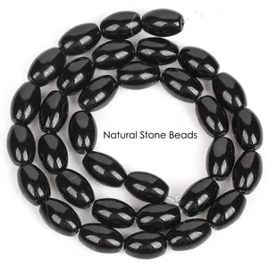 Close-up view of polished black dragon vein agate rice beads for DIY jewelry making projects
