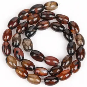 Close-up of polished coffee brown dragon vein agate rice beads for DIY jewelry crafting
