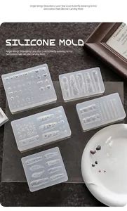 Varietà di stampi 3D in silicone per nail art con cuori, ali e farfalle eleganti.