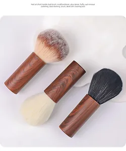 Close-up of three walnut handle nail dust brushes with various soft fiber bristles