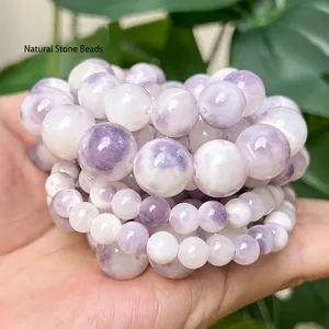 Detailed view of purple and white Persian jade round beads in various sizes for DIY crafts