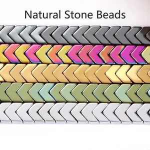 Detailed view of arrow-shaped electroplated hematite beads in various metallic colors