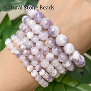 Close-up of natural purple and white Persian Jade round beads in various sizes.