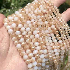 Macro view of faceted peach and white opaque glass beads for handmade DIY jewelry making
