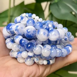 Detailed macro shot of 4-12mm blue and white Persian jade chalcedony round beads.