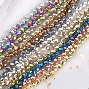 Detailed close-up of faceted heart-shaped hematite beads in multiple metallic colors for DIY