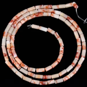 Detailed macro view of 4x2mm cylindrical natural stone beads with orange marble patterns.