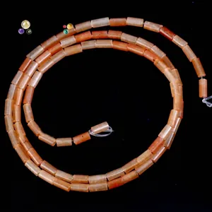 Close-up detail of 4x2mm orange cylindrical natural stone beads for DIY jewelry making