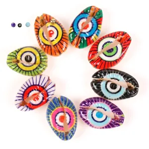 Macro view of colorful cowrie shell beads with vibrant printed evil eye patterns