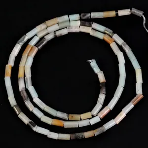 Macro view of 4x2mm multi-colored cylindrical natural stone beads for DIY jewelry making.