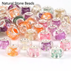 Close-up view of various large-hole glitter beads for DIY jewelry making