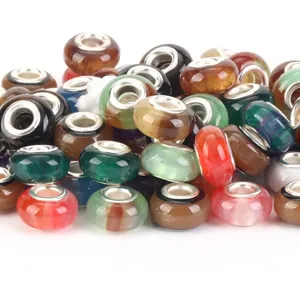 Close-up of vibrant colorful natural stone beads with large metal-lined holes