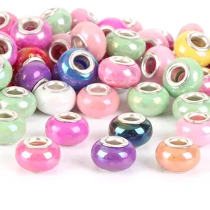 Detailed macro shot of mixed colorful large-hole beads with metal grommets for DIY jewelry