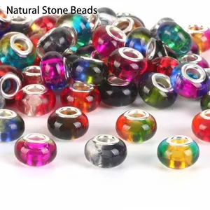 Close-up view of various colorful large hole glass beads for DIY charm bracelet making