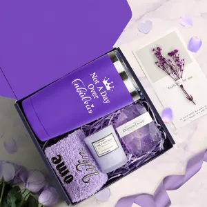 Detail view of purple birthday gift basket set for women with tumbler and candle.