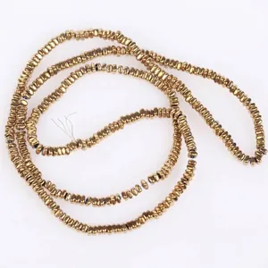 Close-up detail of 2x1mm golden flat square hematite beads for DIY jewelry making