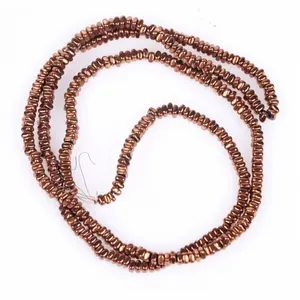 Detail view of 2x1mm metallic brown rounded square hematite center hole flat beads