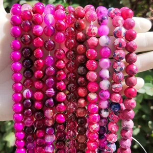Detailed view of assorted rose red natural stone and chalcedony beads for jewelry