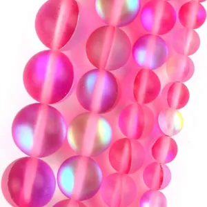 Close-up detail of rose red iridescent round glass beads for handmade jewelry crafts
